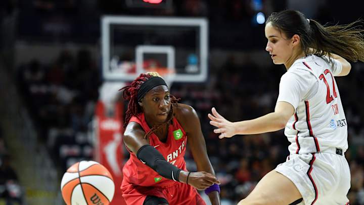 Brittney Sykes fighting for control during a WNBA game, showcasing athleticism and leadership