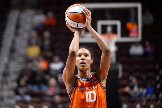 Tina Charles mentoring young Connecticut Sun teammates during a 2025 WNBA game