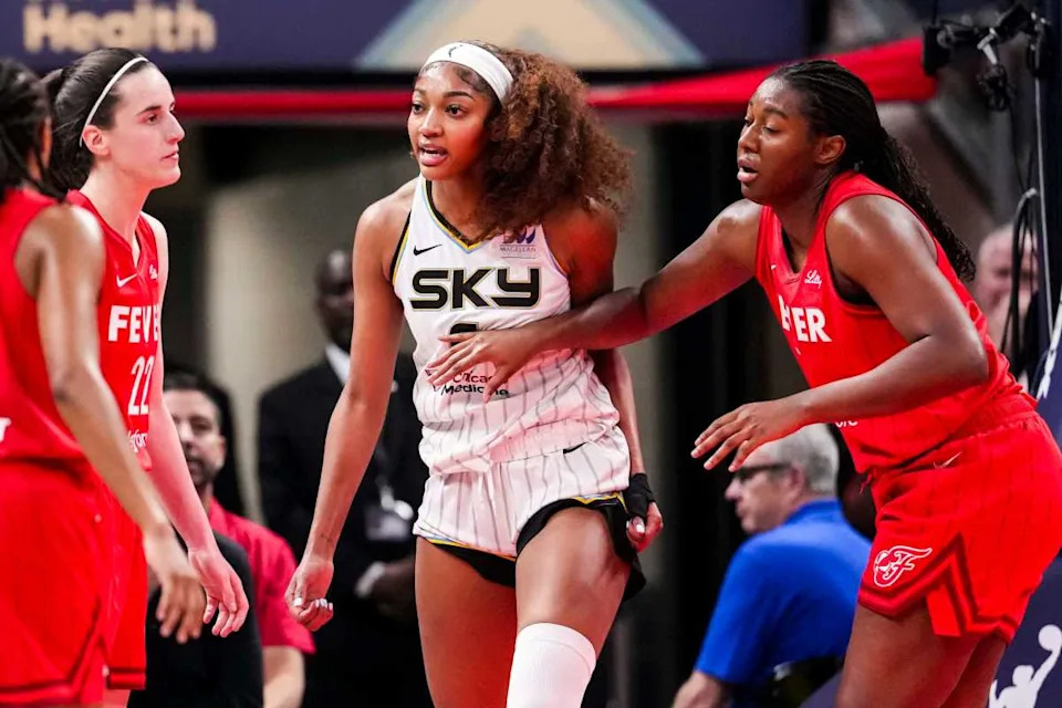 Angel Reese and Caitlin Clark lock eyes during a tense WNBA game, symbolizing the battle of star athletes.