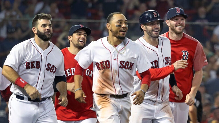 Mookie Betts celebrates with teammates after a Red Sox victory in 2018