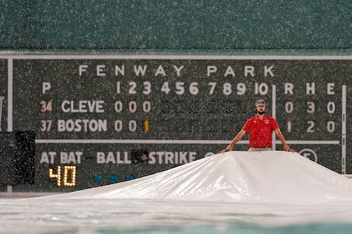 Fans waiting as rain postpones the Red Sox game today at Fenway Park